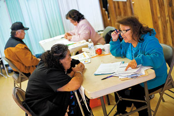 Evalyn Lee talks with clients during a survey screening process on Tuesday at the Iyanbito Chapter House. The community was participating in a uranium exposure screening program. © 2011 Gallup Independent / Brian Leddy 